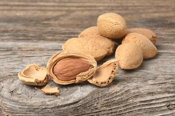 Almonds on rustic wooden background