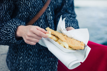 Woman eating fish and chips