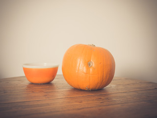 Pumpkin and bowl on table