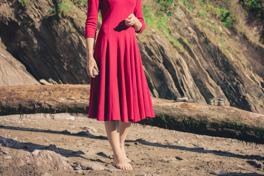 Woman in red standing on the beach