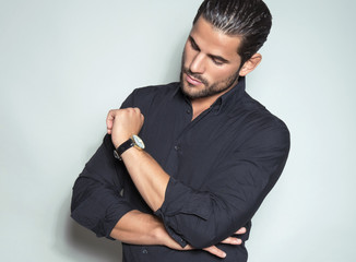 handsome young man in black dress shirt wearing a wristwatch