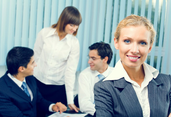 Fototapeta premium Portrait of successful businesswoman and business team at office