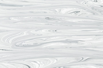 Mix of a white and black paint, closeup.