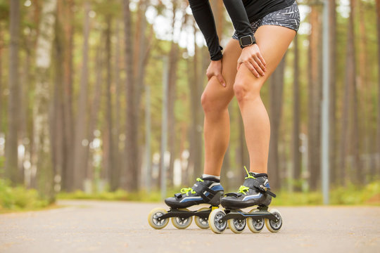 Fit woman on roller skates resting 