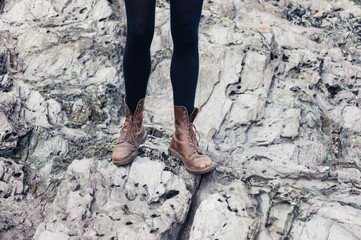 Woman in hiking boots standing on rocks