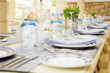 table setting with plenty of restaurant glasses and cutlery
