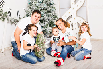 Christmas Family Portrait In Home Holiday Living Room, Kids and Baby With Present Gift Box, House Decorating By Xmas Tree