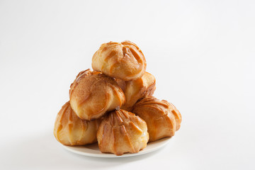 Eclairs with cream on a white background