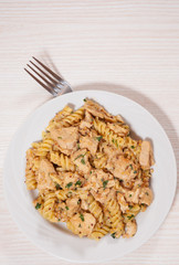 Sliced fried chicken fillet in a creamy and mustard sauce. with fusilli pasta