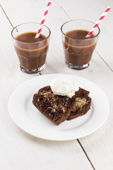 Chocolate and vanilla cake with ice cream and cocoa drink on a w