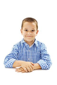 Photo of adorable young happy boy looking at camera.Isolated on white background

