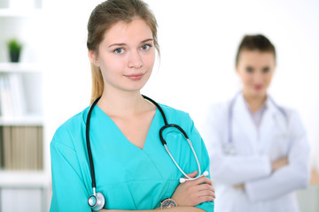 Fototapeta premium Portrait of young female surgeon doctor in a hospital