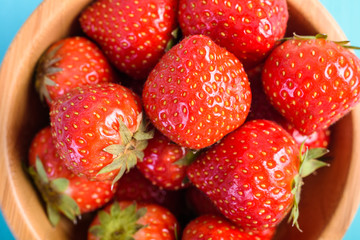 Strawberry Wood Bowl On Blue Boards Background