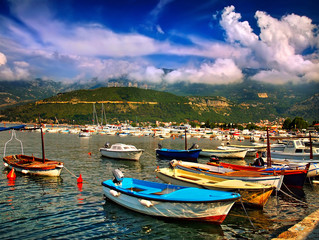 Fototapeta na wymiar pier with boats and yachts in mountains in Montenegro