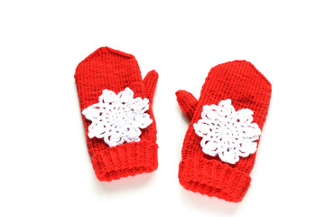 Red knitted mittens with snowflakes