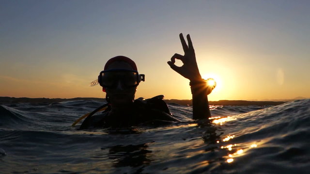 diver on the surface showing sign  ok