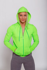 Attractive sporty female in green hoodie.