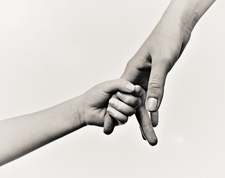 Child and mother hands, black and white retro stylization