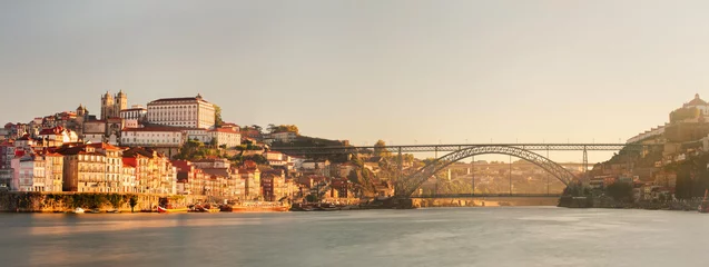 Fotobehang Porto city, Portugal October 17, 2013: panorama of Ribeira, Dom Luis Bridge and Douro river in the sunset © GavranBoris