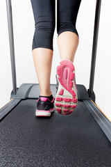 Cardio training on treadmill on pink black sport shoes
