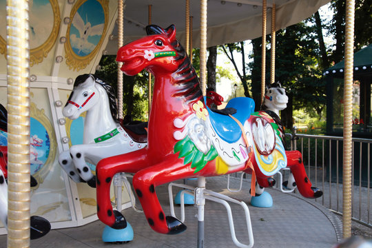 Colourful vintage carousel in a summer park.