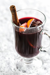 Glass of mulled wine in snow