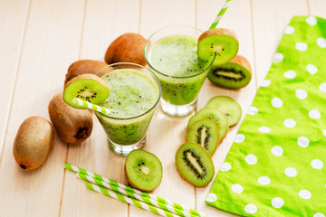 Fruit smoothie with fresh green kiwi on a wooden background