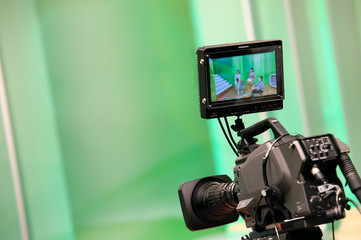 Professional video camera with a monitor in a TV studio