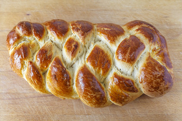 Loaf of sweet braided bread on Table