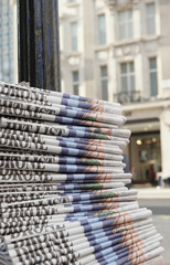 stack of the newspapers in the city