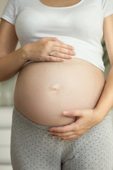 Toned shot of young pregnant woman on the 9 month