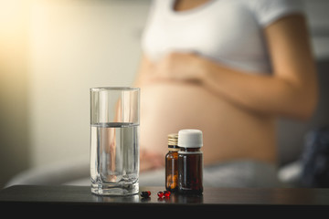 Conceptual photo of pregnancy healthcare. Medicines on table nex