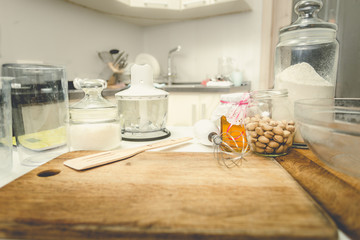Toned shot of utensils and ingredients for baking on table at ki