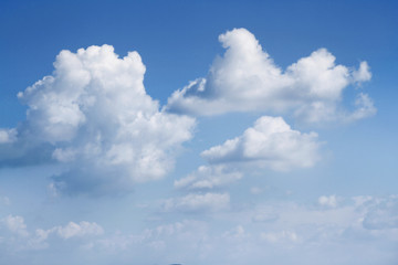 Big fluffy soft white clouds in blue sky