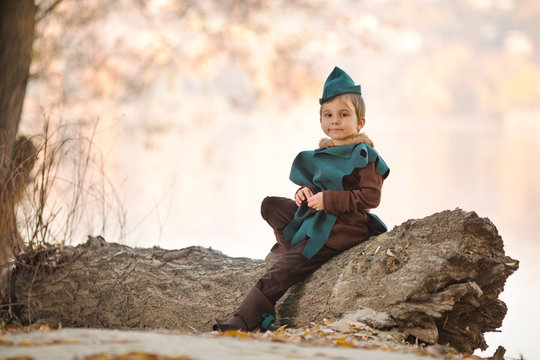 Cute little boy dressed as a knight playing outdoors