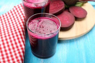 Glasses of beet juice with vegetables on table close up