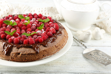 Cake with Chocolate Glaze and raspberries on color wooden background