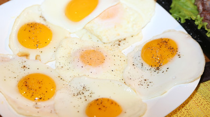 many chicken eggs cooked fried to a hearty breakfast