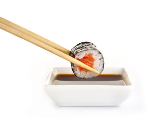 Dipping roll in sauce isolated on white