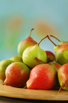 Ripe tasty pears on bright background