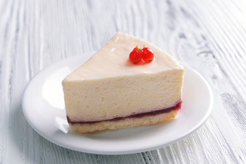 Delicious cheesecake with berries on table close up