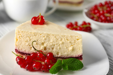 Delicious cheesecake with berries on table close up