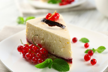 Delicious cheesecake with berries on table close up