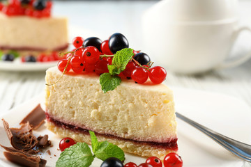 Delicious cheesecake with berries on table close up