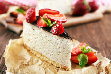 Delicious cheesecake with berries on table close up