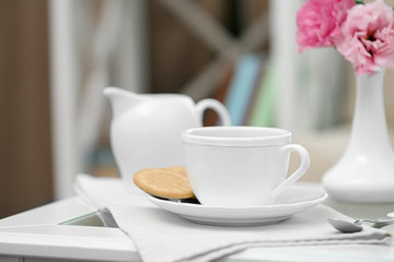 Cup of coffee on table in living room