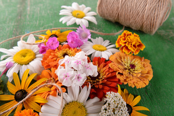 Fresh colorful flowers on wooden table, closeup
