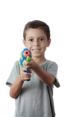 Little boy playing with plastic water gun isolated on white.