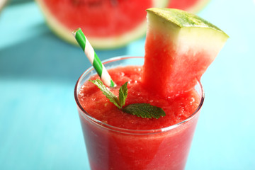Glass of watermelon juice on wooden table, closeup