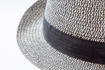 Close up of the brim and ribbon on a black and white hat